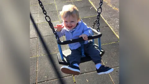 Toddler in swing