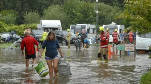 Malcolm Richards/Athena Pictures Campers are helped to safety after flooding near Wisemans Bridge, in Pembrokeshire