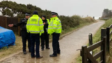 Alex Dunlop/BBC Emergency services at the scene