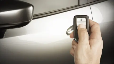 Getty Images A man using a Lexus remote to unlock his car