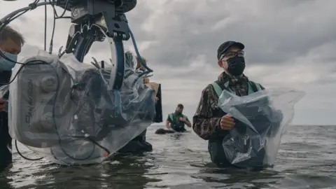 Aidan Monaghan / © 2022 Focus Features, LLC Crew members filming on the set of The Northman