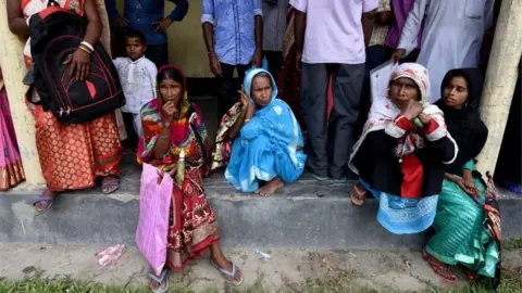 Reuters Villagers wait outside the National Register of Citizens (NRC) centre to get their documents verified by government officials, at Mayong Village in Morigaon district, in the northeastern state of Assam, India July 8, 2018.