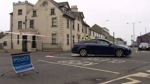 Police at the scene of a man's death in Ballymena