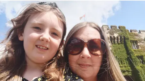 BBC Hannah Nash and her daughter Isla outside a castle