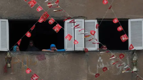 Reuters Women look from the windows of their house in the town of Toukh, Egypt