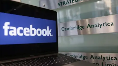 Getty Images Facebook and Cambridge Analytica signs