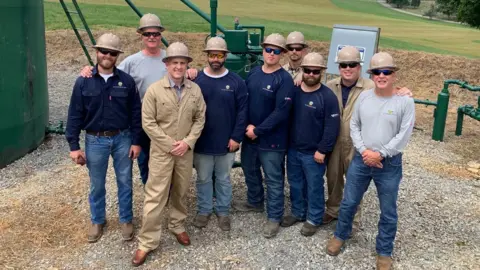 DGO Rusty, third left, with DGO workers