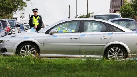 South Beds News Agency Police by a car