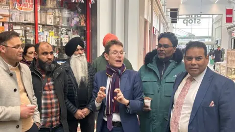 Andy Street, Desmond Jadoo and Khalid Mahmood with traders