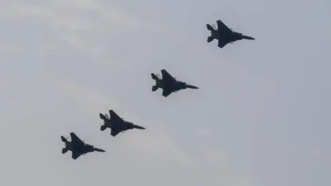 Getty Images A line of four fighter jets in the sky