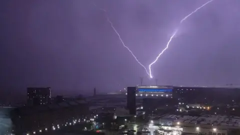 Lightning strike lighting up the sky near Everton FC's new stadium at Bramley-Moore Dock in Liverpool