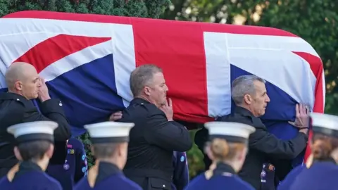 The coffin of Sir David Amess is carried into St Mary"s Church in Prittlewell, Southend for his funeral service.