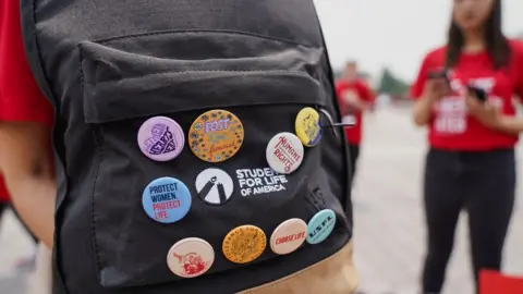 Students for Life coordinator Natalee Wilson shows off her backpack buttons