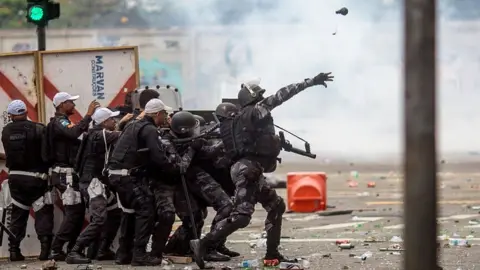 AFP Riot police disperse fans of Flamengo football club taking part in a celebration parade