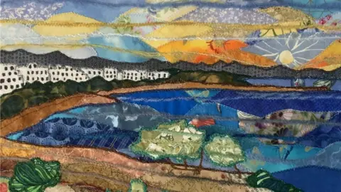 Josie Russell A patchwork artwork of the sea and a row of white houses
