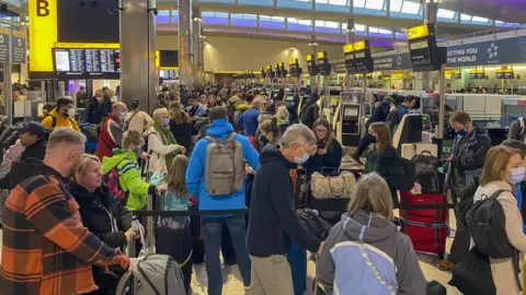 PA Media Passengers at Heathrow Airport on 9 April 2022