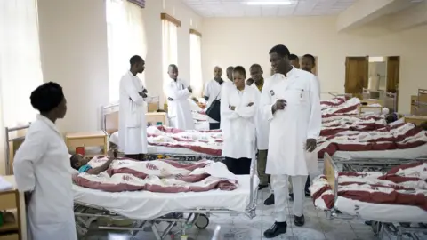 AFP Dr. Denis Mukwege (c), a French trained gynecologist talks to staff and students during a round at the ward for recovering patients on November 2, 2007 in Bukavu, DRC.