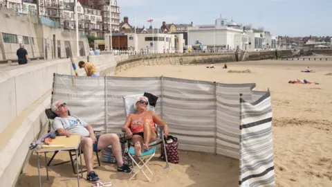 PA Media Sunbathers on Bridlington Beach in Yorkshire