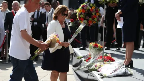 AFP Members of the public laying flowers