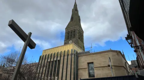 The front of Leicester Cathedral with the newly-built heritage centre with its copper roof