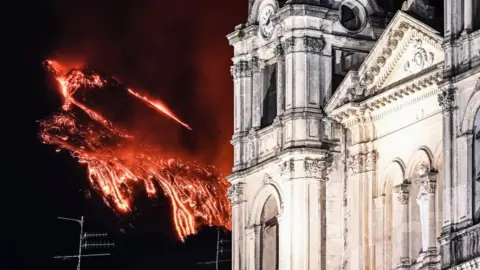 Getty Images Lava spewing in the background of a cathedral