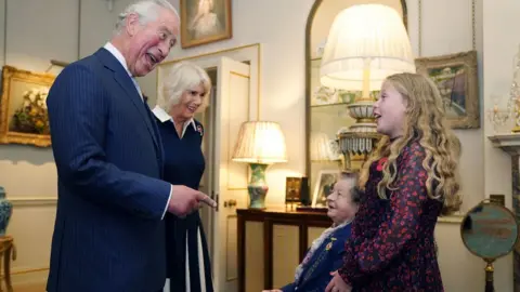 PA Media The Prince of Wales and Duchess of Cornwall (second left) talk with Jill Gladwell, aged 95, and Maisie Mead, 10, who are the oldest and youngest of 10 Royal British Legion (RBL) Poppy Appeal collectors at Clarence House, London, during the official launch of the centenary poppy appeal.