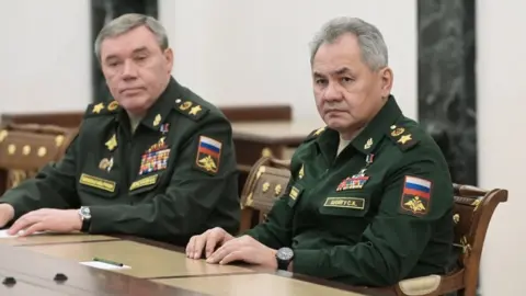 EPA/Kremlin pool Russian Defence Minister Sergei Shoigu (R) and Russian General Staff Chief Valery Gerasimov (L) attend a meeting with Russian President, in Moscow, Russia, 27 February 2022