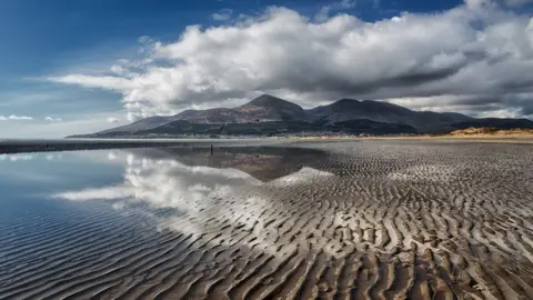 AndySG The Mourne Mountains with the 6 main peaks shown here including Slieve Donard the highest at 849 metres. This is the beach at Murlough as accessed from the National Trust car park and the National Nature Reserve
