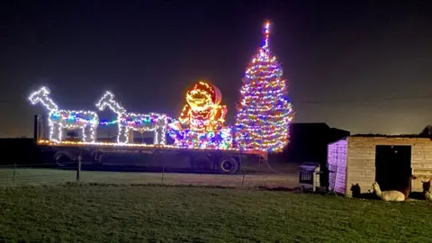 Tom Moore Christmas bale sculpture in 2021 at White Stacks Farm, in Kibworth, Leicestershire