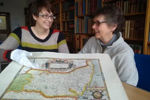 Suffolk Record Office Emily Tillett and Sarah Steggles with Saxton's 1575 Map of Suffolk