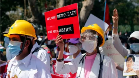 Getty Images Myanmar doctors march as they take part in a demonstration against military coup