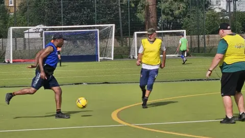 Walking football players