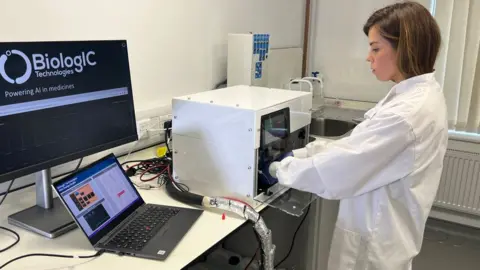 Steve Hubbard/BBC Scientist working with a medicine machine at Biologic