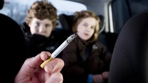 Getty Images Children growing up with a smoking parent
