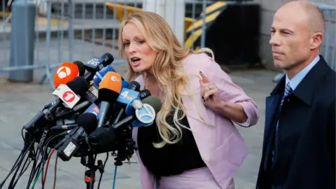 Reuters Stormy Daniels and Michael Cohen appear outside court