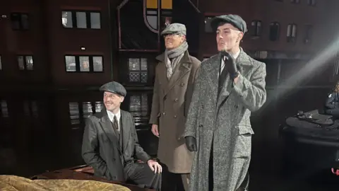 Spencer Elcock A group of men in 1940 clothing on the end of a boat in a canal in Birmingham