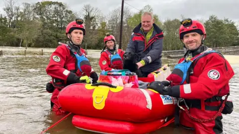 Holidaymaker and dog rescued by boat