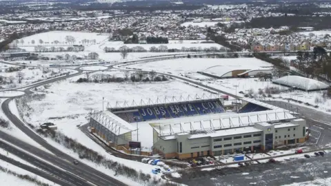 PA Media Colchester United's stadium in snow