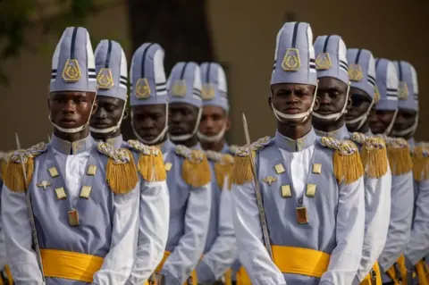 JEROME FAVRE/EPA A new promotion of army officers stand at attention during Armed Forces Day in Camp Dial Diop.