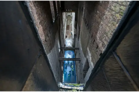 PA Media View down through the floors along the main corridor in the Glasgow School of Art's Mackintosh building in Glasgow, which was significantly damaged by fire on 15 June 2018.