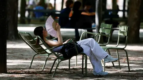 Reuters Image shows woman fanning herself