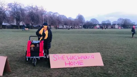 Kate Graham A protester on Hailey Fields in Llandaff North with a placard: "She was walking home"