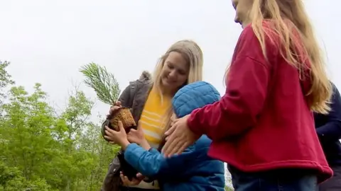 A family planting a tree