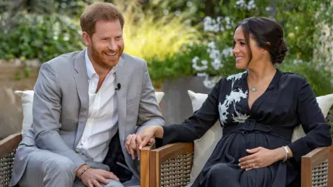 Harpo Productions/Joe Pugliese/Handout via REUTERS Prince Harry and Meghan, The Duke and Duchess of Sussex, give an interview to Oprah Winfrey in this undated handout photo.