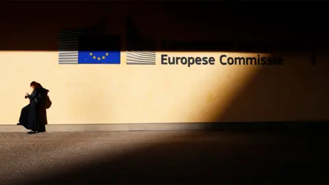 Reuters A woman is pictured outside the European Commission headquarters in Brussels