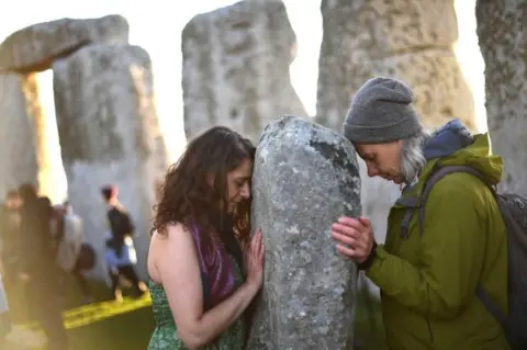 Getty Images Two people at Stonehenge