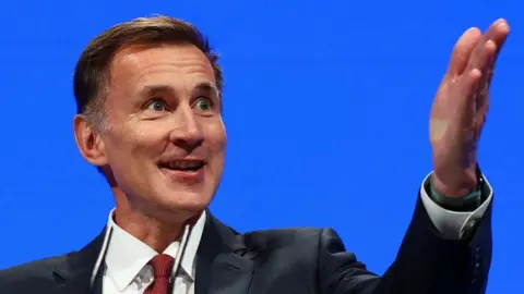 Reuters Chancellor Jeremy Hunt speaking at the Conservative party conference