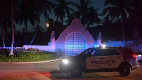 EPA A police car stands guard outside Mar-a-Lago on 8 August