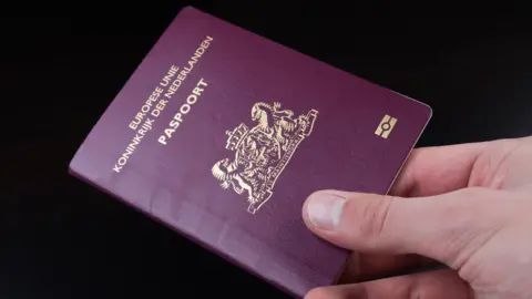 Getty Images A person holds a Dutch passport