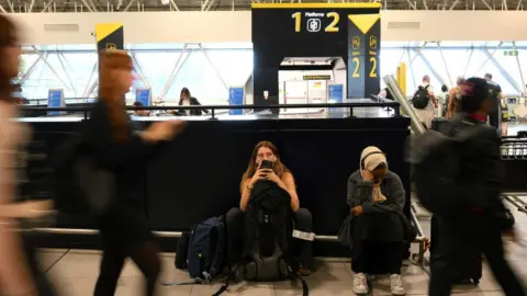 Getty Images Passengers waiting at Gatwick Airport